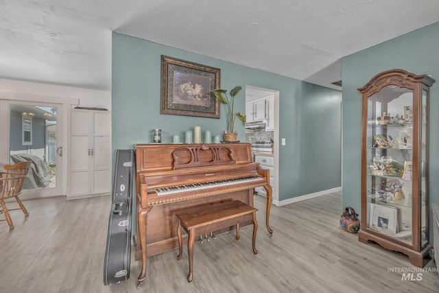 sitting room with light wood-style flooring and baseboards