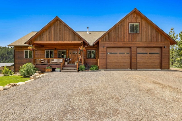 3383 Ridge Dr, Mccall, ID 83638 - view of front of home featuring gravel driveway, a garage, covered porch, and roof with shingles