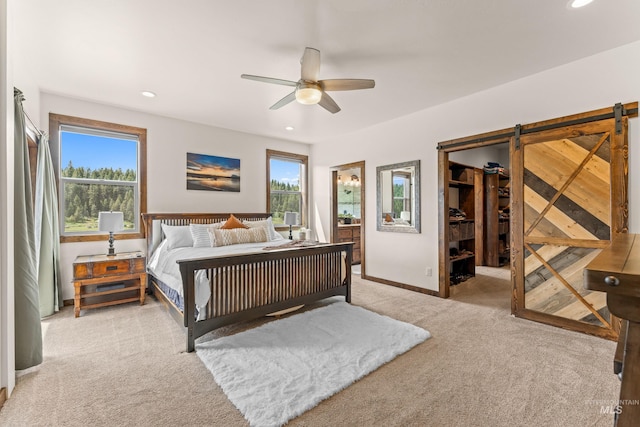 3383 Ridge Dr, Mccall, ID 83638 - bedroom with light colored carpet, recessed lighting, ceiling fan, a spacious closet, and a barn door