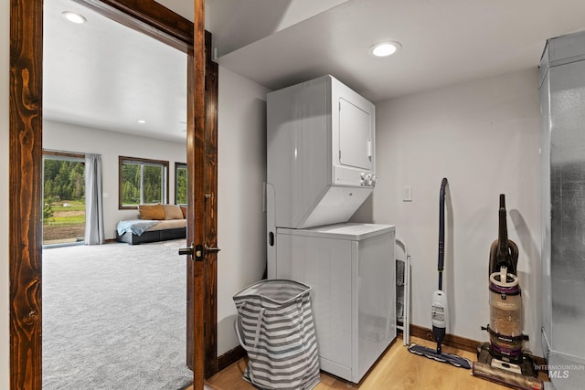 3383 Ridge Dr, Mccall, ID 83638 - laundry room with stacked washer and clothes dryer, recessed lighting, light wood-style floors, and arched walkways