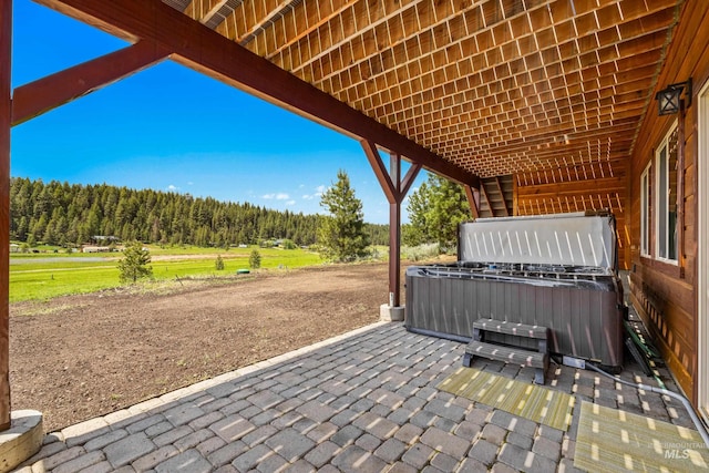 3383 Ridge Dr, Mccall, ID 83638 - view of patio featuring a hot tub and a wooded view