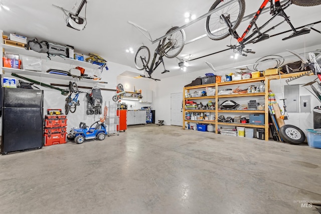 3383 Ridge Dr, Mccall, ID 83638 - garage featuring electric panel, freestanding refrigerator, and a garage door opener