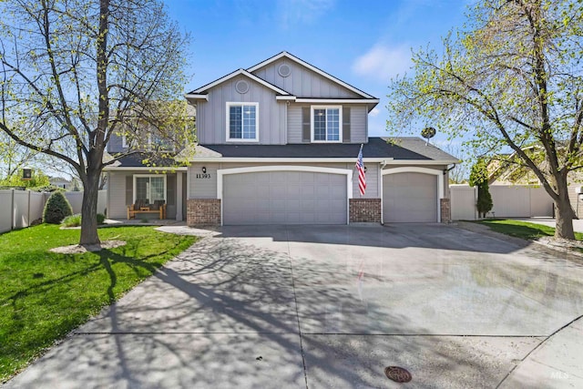 traditional-style house with brick siding, driveway, a garage, and fence