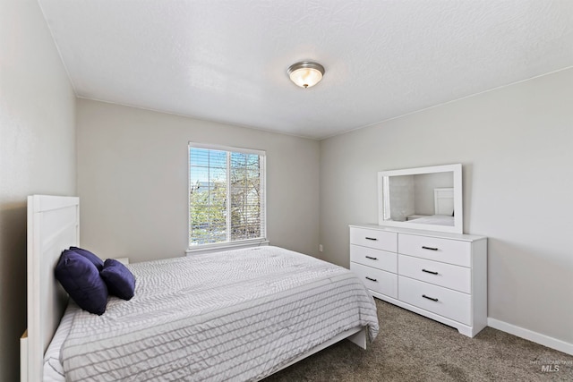 bedroom featuring baseboards, carpet floors, and a textured ceiling