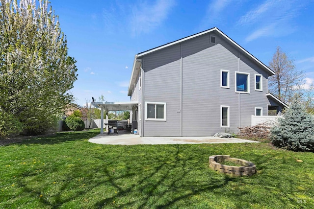 rear view of house featuring a pergola, a patio, an outdoor fire pit, fence, and a yard