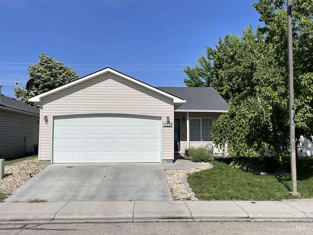 2329 S Garland St, Nampa, ID 83686 - ranch-style home with driveway, a garage, and a front lawn