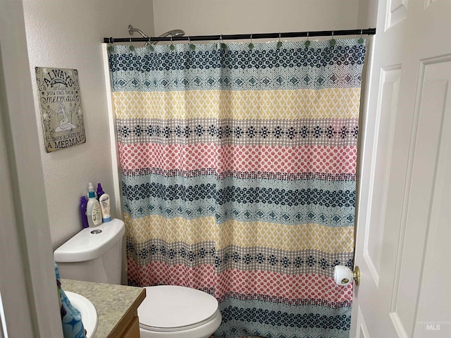 2329 S Garland St, Nampa, ID 83686 - full bathroom featuring vanity, toilet, a textured wall, and curtained shower