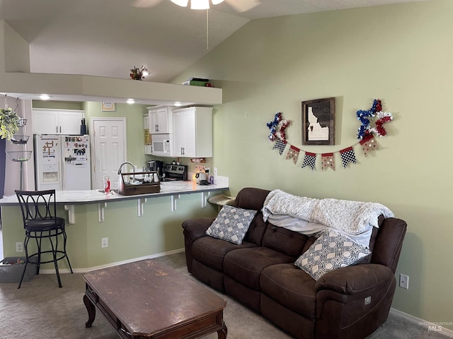 2329 S Garland St, Nampa, ID 83686 - living area featuring a ceiling fan, vaulted ceiling, carpet, and baseboards