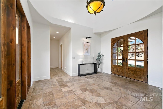 tiled entrance foyer featuring french doors