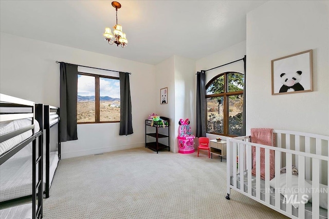 bedroom with carpet and an inviting chandelier