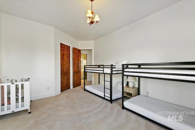 carpeted bedroom featuring a notable chandelier