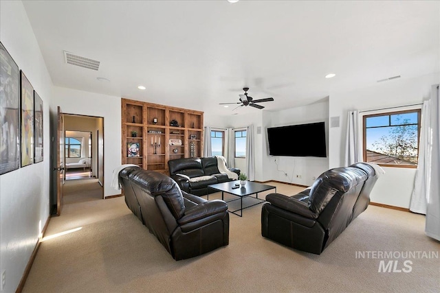 living room with carpet floors and ceiling fan