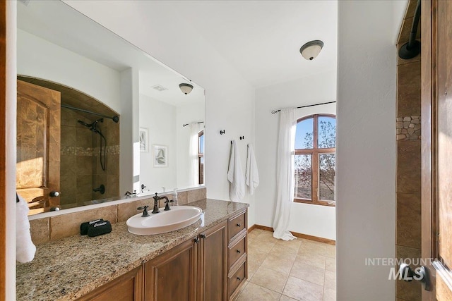 bathroom featuring tile floors and large vanity