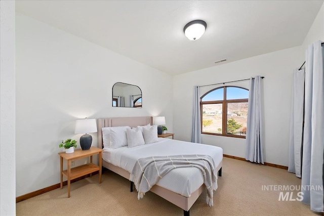 bedroom featuring light carpet