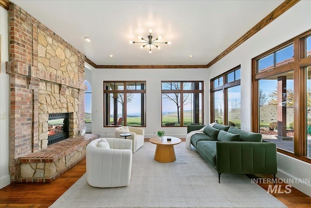 living room with hardwood / wood-style floors, a fireplace, and crown molding