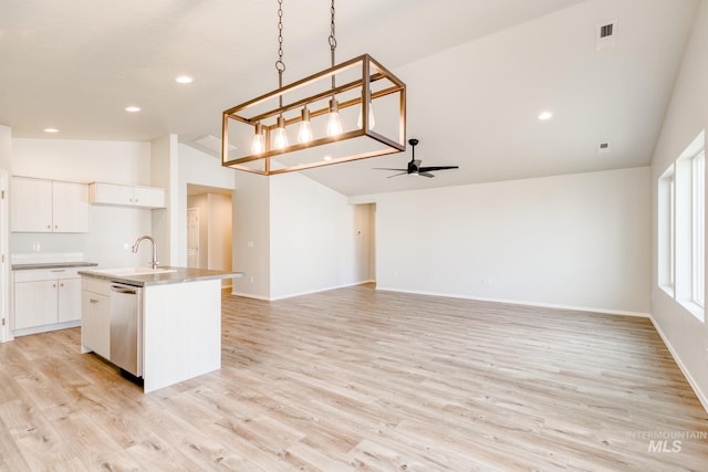 kitchen with vaulted ceiling, a sink, light wood-style floors, dishwasher, and ceiling fan