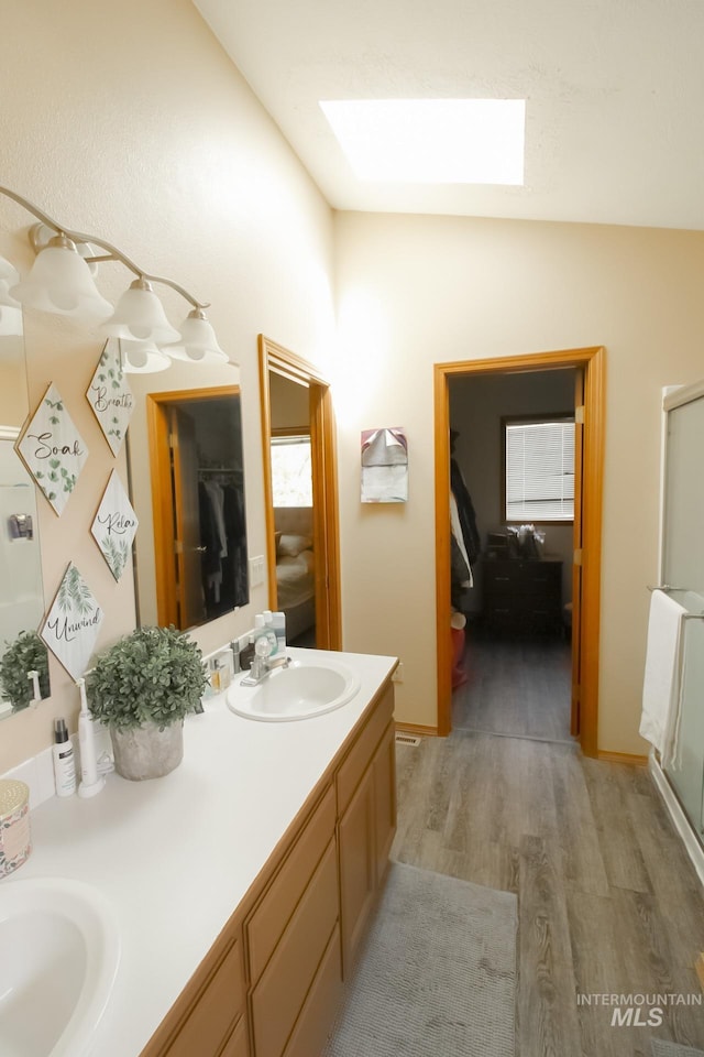 275 E Aruba, Meridian, ID 83642 - bathroom with a skylight, wood finished floors, double vanity, and a shower stall