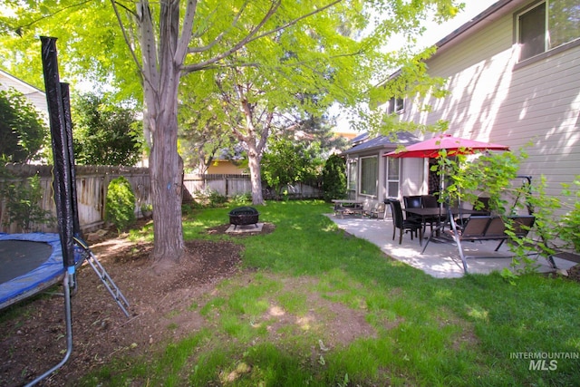 275 E Aruba, Meridian, ID 83642 - view of yard featuring a trampoline, a patio, and a fire pit