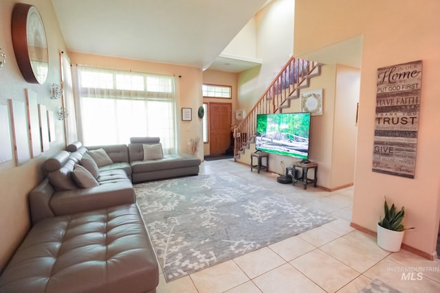 275 E Aruba, Meridian, ID 83642 - tiled living room with stairs, baseboards, and high vaulted ceiling