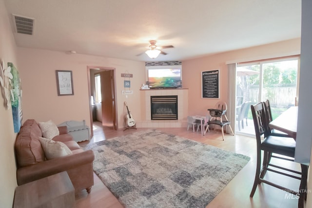 275 E Aruba, Meridian, ID 83642 - living area featuring ceiling fan, a tiled fireplace, and wood finished floors