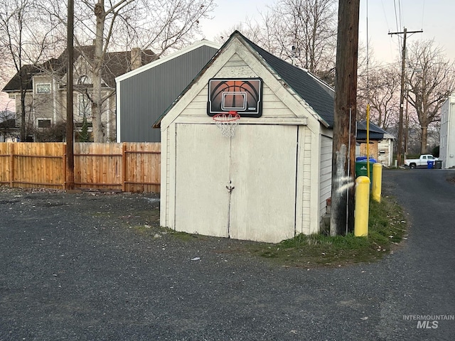 view of shed featuring fence