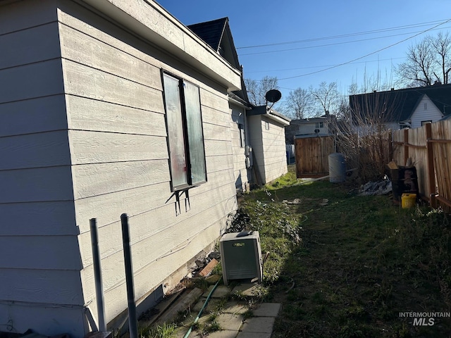 view of side of property featuring fence