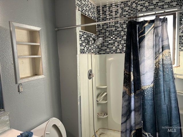 bathroom with a walk in shower and a textured wall