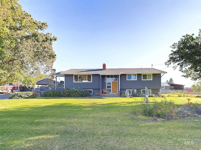 raised ranch featuring a front yard