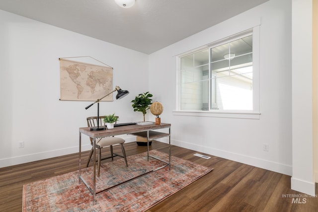 home office with dark hardwood / wood-style flooring