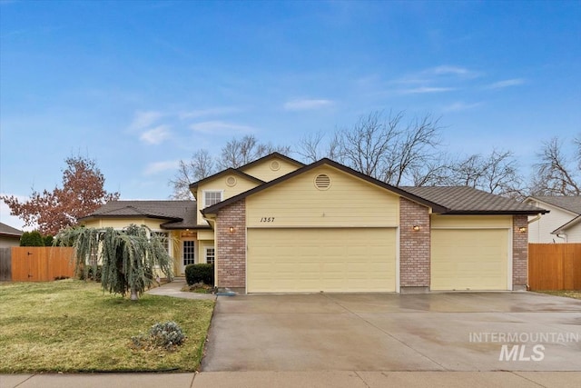 ranch-style house featuring brick siding, a front lawn, fence, driveway, and an attached garage