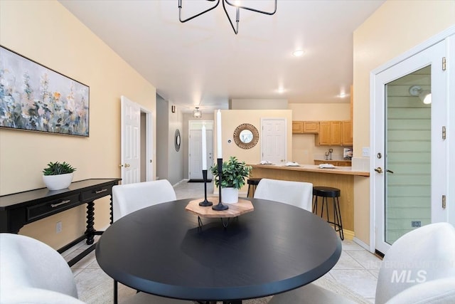 dining area featuring baseboards and light tile patterned flooring