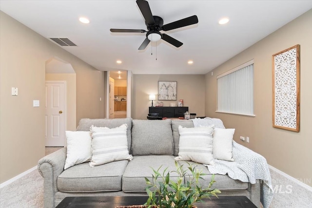 carpeted living area featuring recessed lighting, visible vents, baseboards, and a ceiling fan