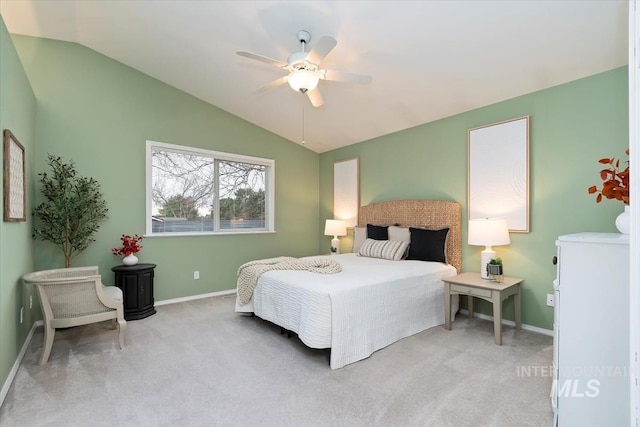 carpeted bedroom with ceiling fan, baseboards, and lofted ceiling