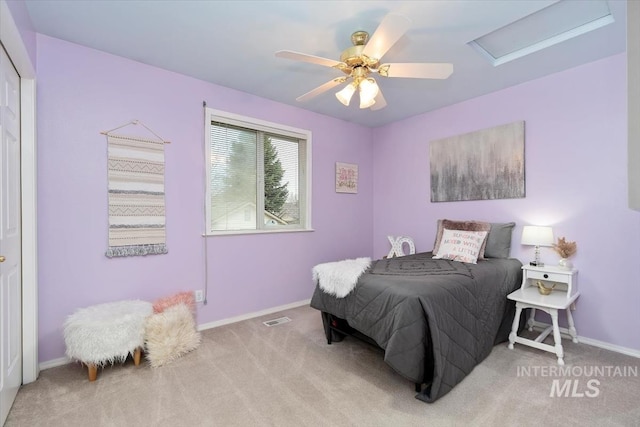 bedroom featuring visible vents, baseboards, carpet, ceiling fan, and attic access