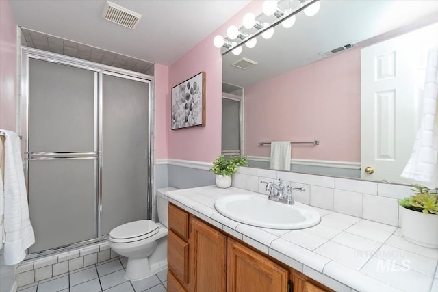 bathroom featuring visible vents and a stall shower