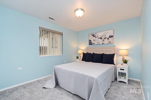 bedroom featuring visible vents, baseboards, and carpet