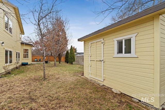 view of yard with an outdoor structure and a fenced backyard