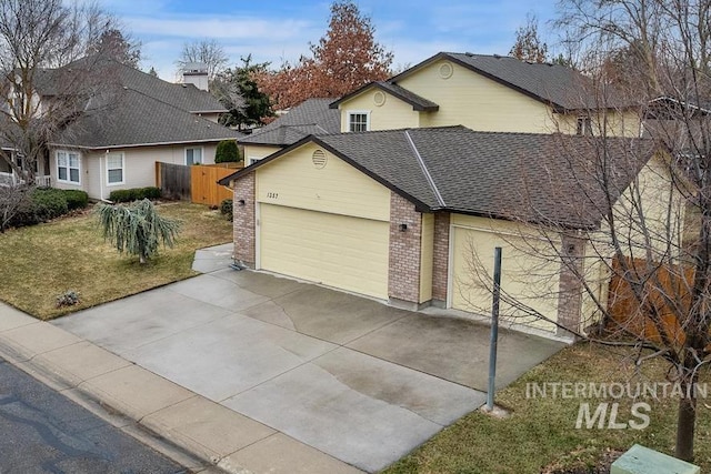 view of front of home featuring driveway, fence, a shingled roof, a garage, and brick siding