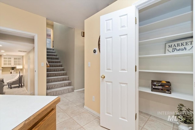 interior space with tile patterned floors and baseboards