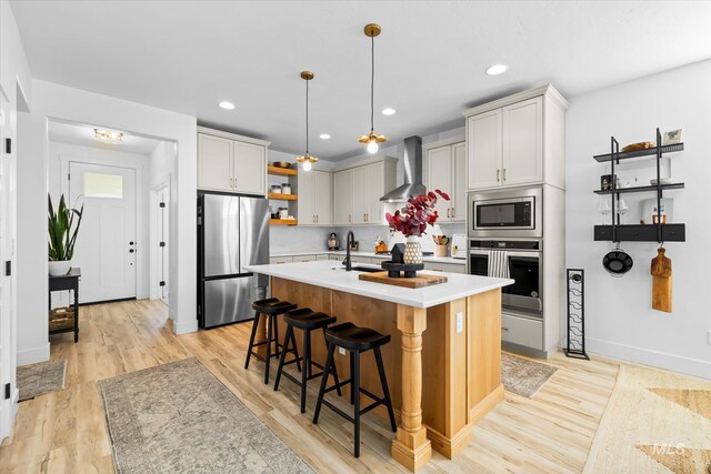 4875 N Glenrock Ave, Meridian, ID 83646 - kitchen featuring stainless steel appliances, open shelves, light countertops, wall chimney range hood, and a kitchen bar