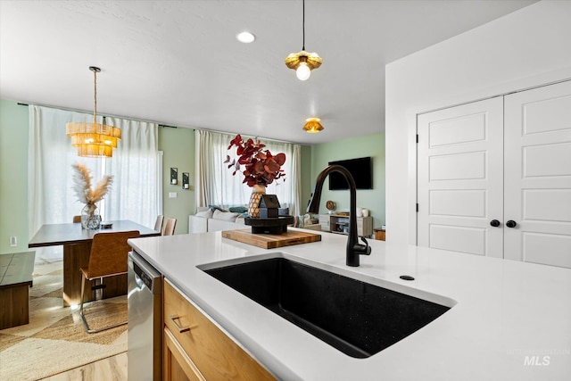 4875 N Glenrock Ave, Meridian, ID 83646 - kitchen featuring decorative light fixtures, dishwasher, light countertops, and a sink