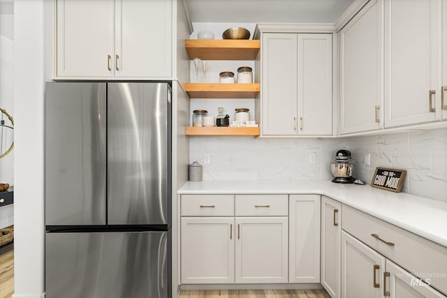 4875 N Glenrock Ave, Meridian, ID 83646 - kitchen featuring open shelves, freestanding refrigerator, decorative backsplash, and light countertops