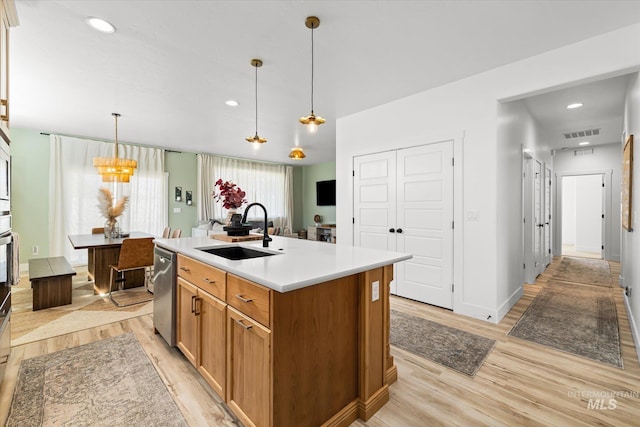 4875 N Glenrock Ave, Meridian, ID 83646 - kitchen with light wood-style flooring, light countertops, dishwasher, a sink, and visible vents