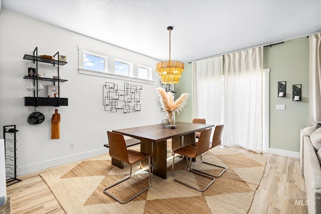 4875 N Glenrock Ave, Meridian, ID 83646 - dining area featuring a chandelier, baseboards, and wood finished floors