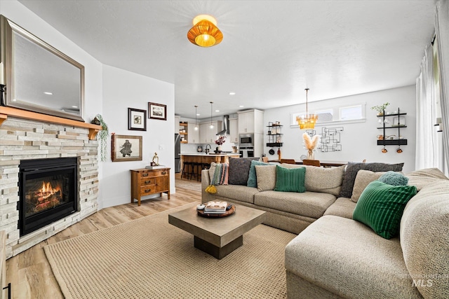 4875 N Glenrock Ave, Meridian, ID 83646 - living area with an inviting chandelier, light wood-style flooring, and a fireplace