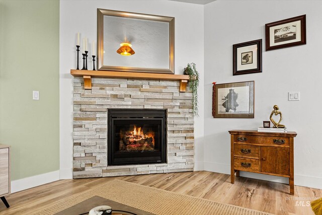 4875 N Glenrock Ave, Meridian, ID 83646 - living area with a stone fireplace, wood finished floors, and baseboards