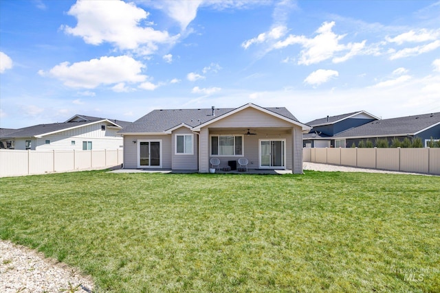 4875 N Glenrock Ave, Meridian, ID 83646 - rear view of house featuring a lawn, a ceiling fan, a fenced backyard, and a patio area