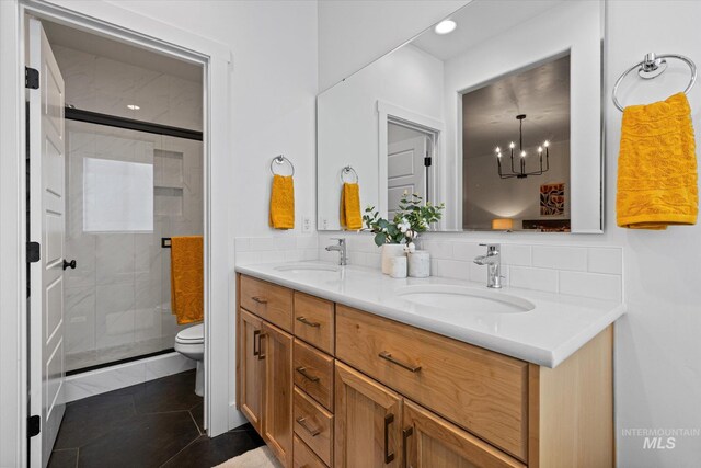 4875 N Glenrock Ave, Meridian, ID 83646 - full bath featuring double vanity, toilet, a shower stall, and a sink