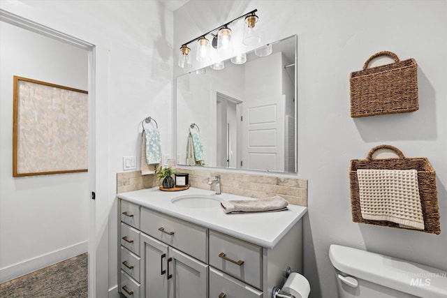 4875 N Glenrock Ave, Meridian, ID 83646 - bathroom featuring tasteful backsplash, vanity, toilet, and baseboards