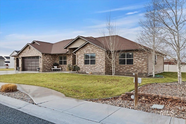 view of front of house featuring a garage and a front lawn